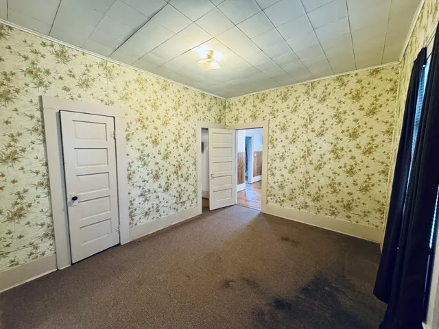 a view of kitchen with refrigerator and window