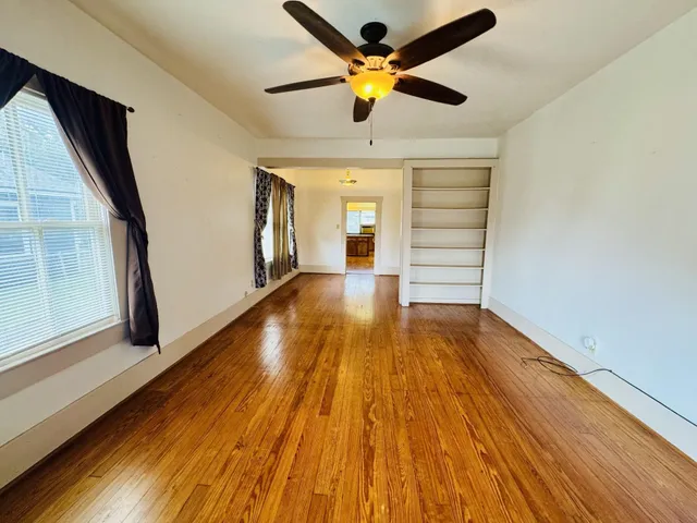 wooden floor in an empty room with a window