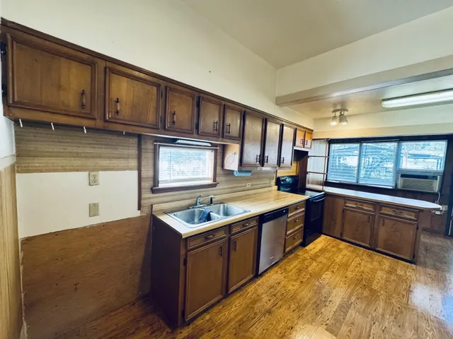 a kitchen with stainless steel appliances granite countertop a stove and a sink