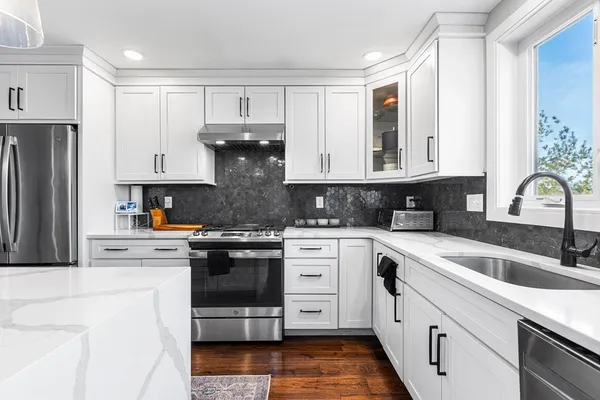 a kitchen with stainless steel appliances granite countertop a refrigerator sink and cabinets