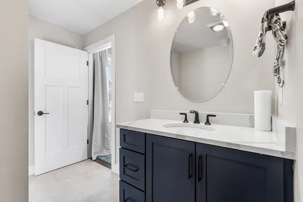 a en suite bathroom with a double vanity sink and a mirror