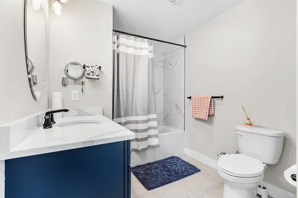a bathroom with a sink a toilet and a mirror