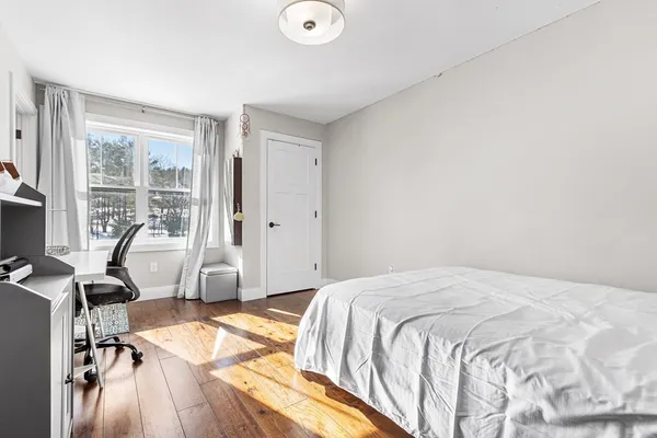 a bedroom with a bed and a desk
