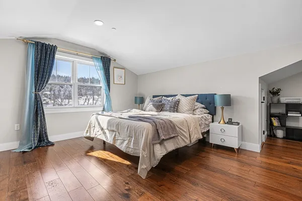 a bedroom with a bed and window