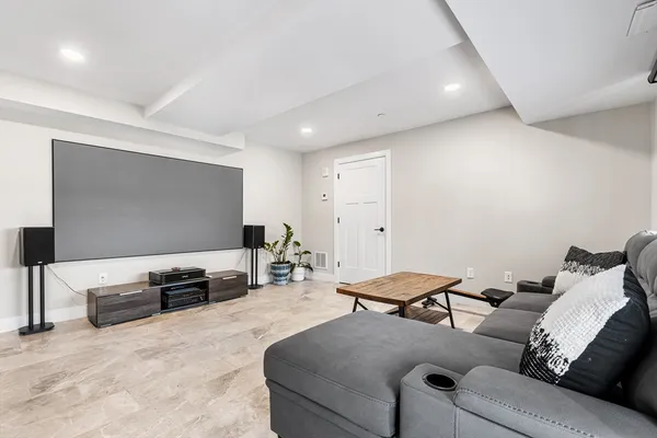 a living room with furniture and next to a window