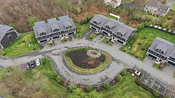 an aerial view of a house with outdoor space and a lake view