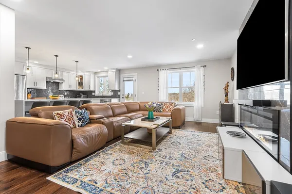 a living room with furniture wooden floor and a flat screen tv