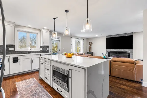 a kitchen with stainless steel appliances and view of living room
