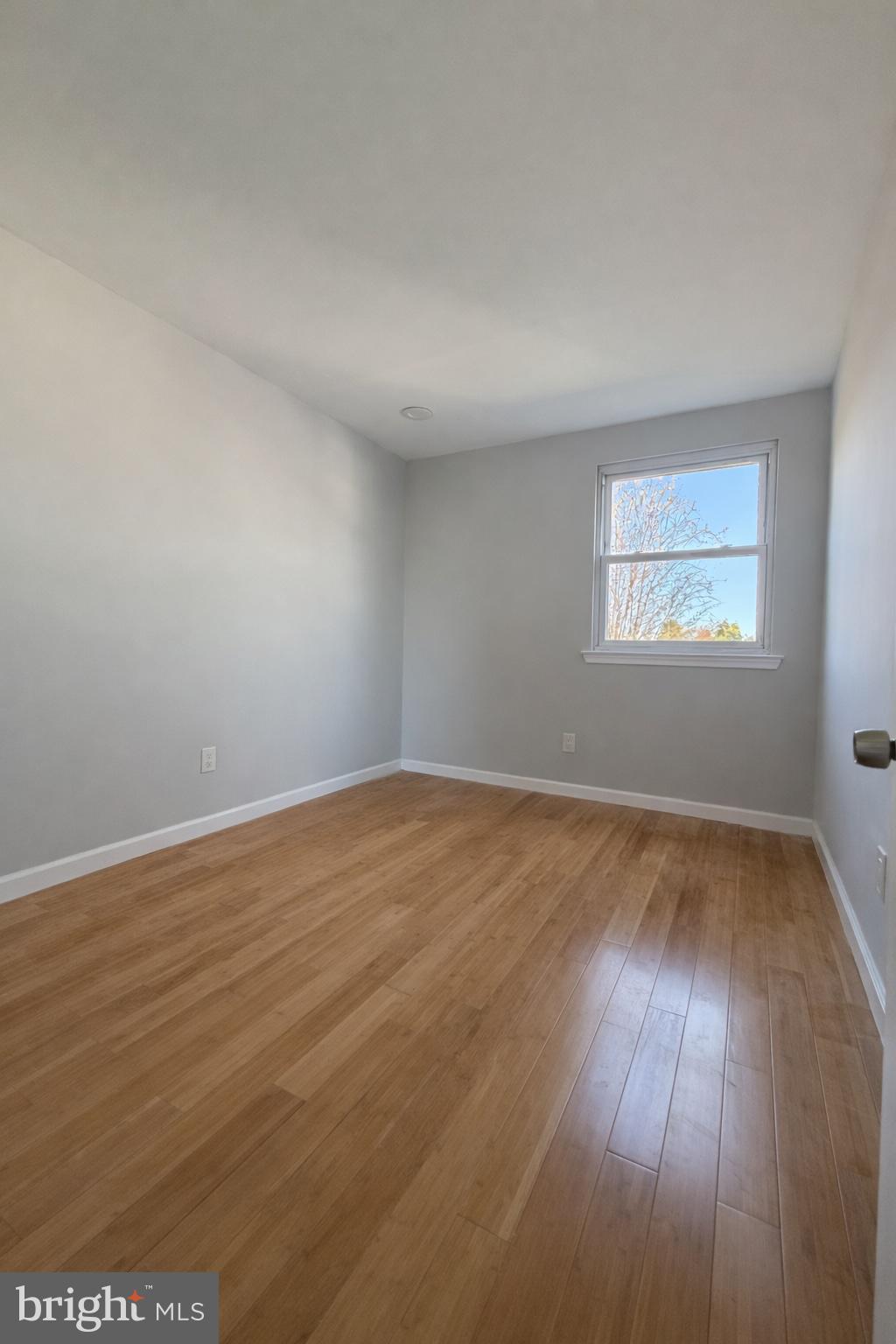 419 Rennard Street Philadelphia, PA 19116 - Photo 7 of 15 an empty room with wooden floor and windows
