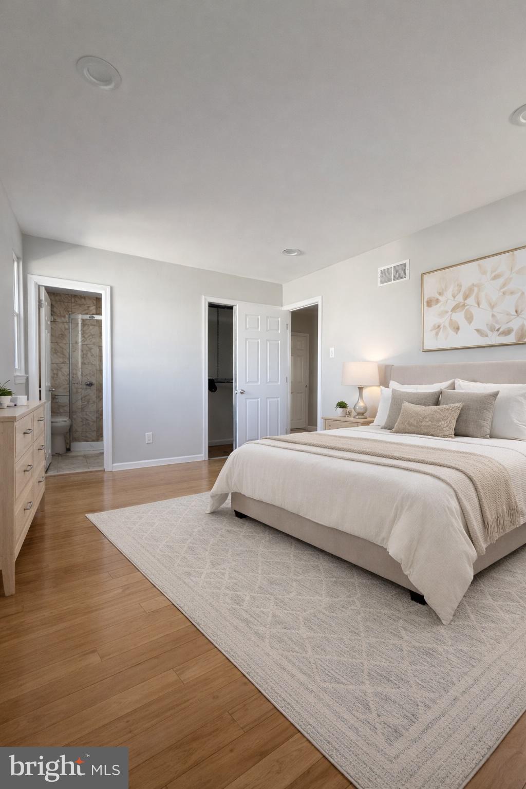 419 Rennard Street Philadelphia, PA 19116 - Photo 10 of 15 a bedroom with a large bed and wooden floor