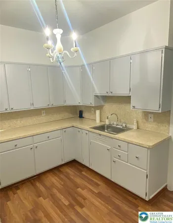 a kitchen with a sink cabinets and window