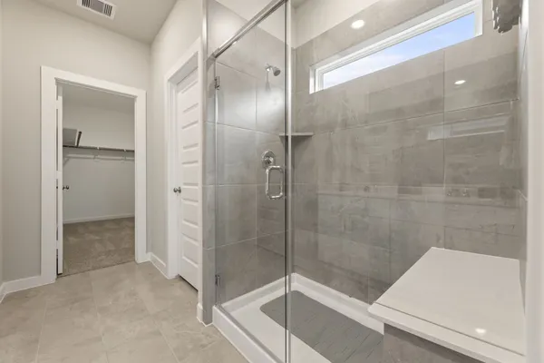 a bathroom with a shower and a sink