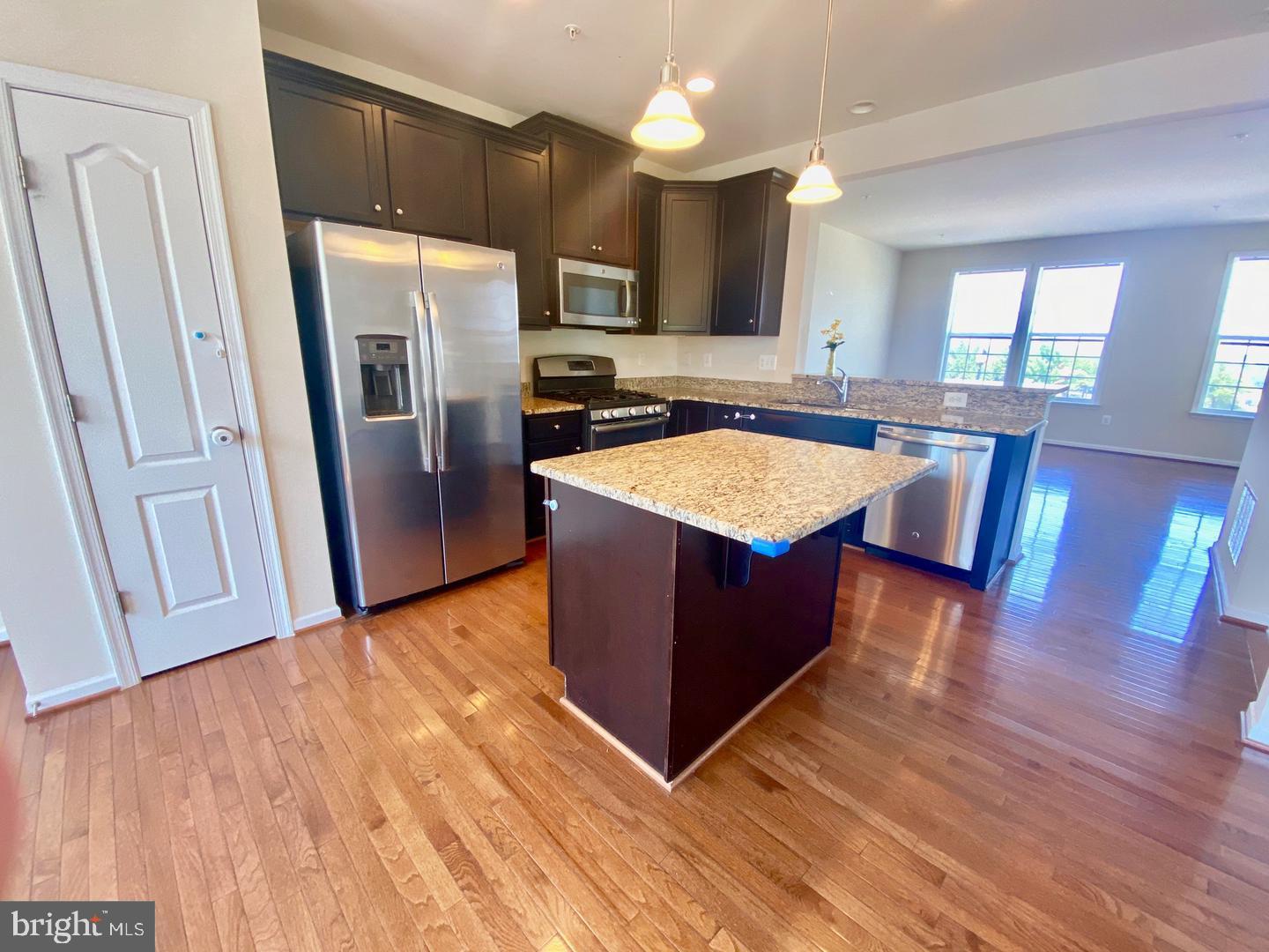 1100 Frontline Drive Frederick, MD 21703 - Photo 7 of 19 a kitchen with wooden floors and refrigerator