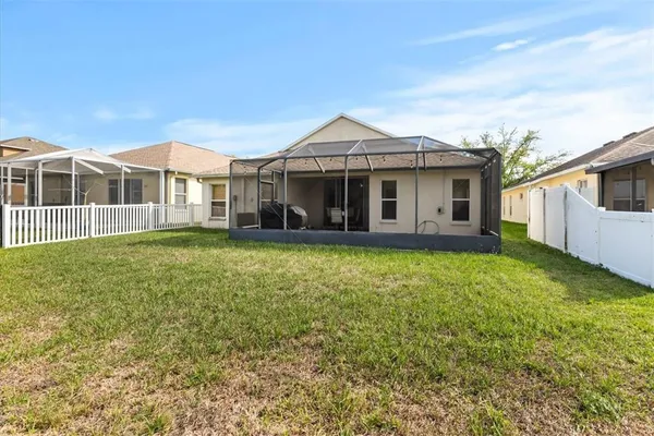 a view of a house with a yard and sitting area