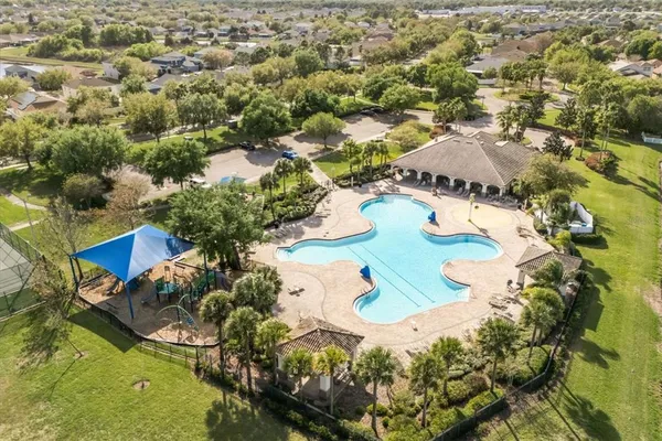an aerial view of a house with a yard and lake view