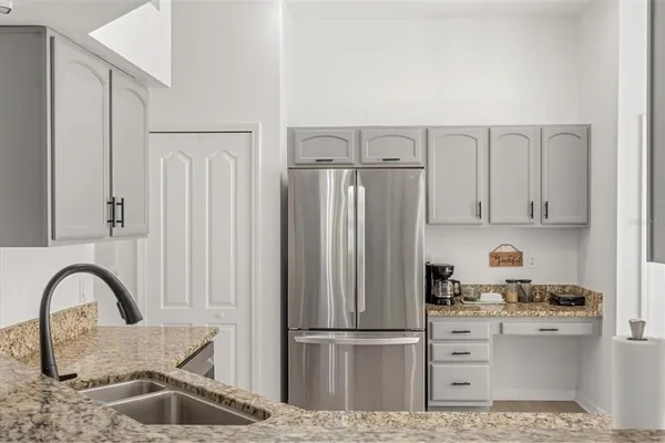 a kitchen with cabinets and refrigerator
