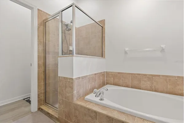 a bathroom with a tub and a shower
