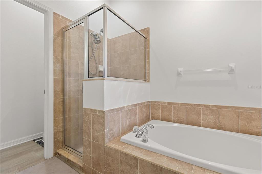 11478 Weston Course Loop Riverview, FL 33579 - Photo 9 of 22 a bathroom with a tub and a shower