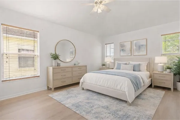 a bed room with a bed a dresser and a window