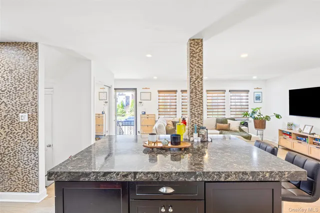 a backyard of a house with barbeque oven table and chairs