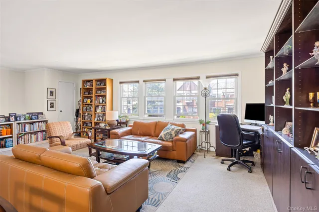 a living room with furniture and large windows