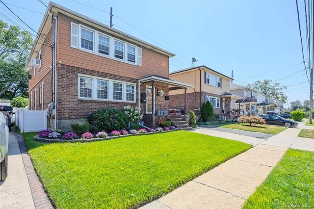 a front view of a house with a yard patio and swimming pool