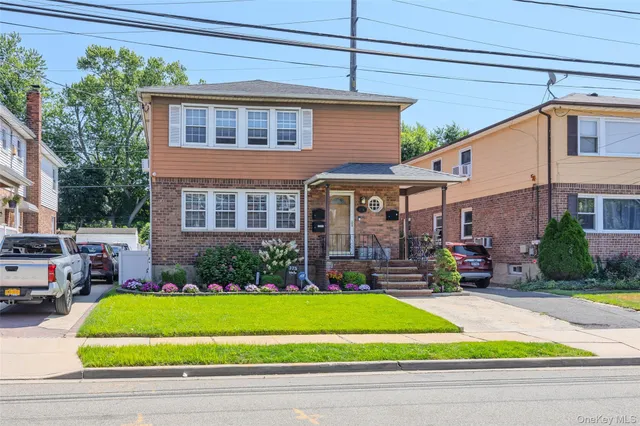 a front view of a house with a yard and table