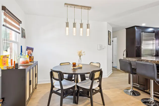 a dining room with furniture and wooden floor