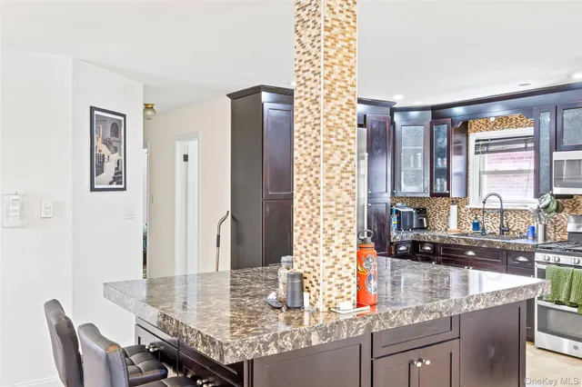 a kitchen with granite countertop a sink and cabinets