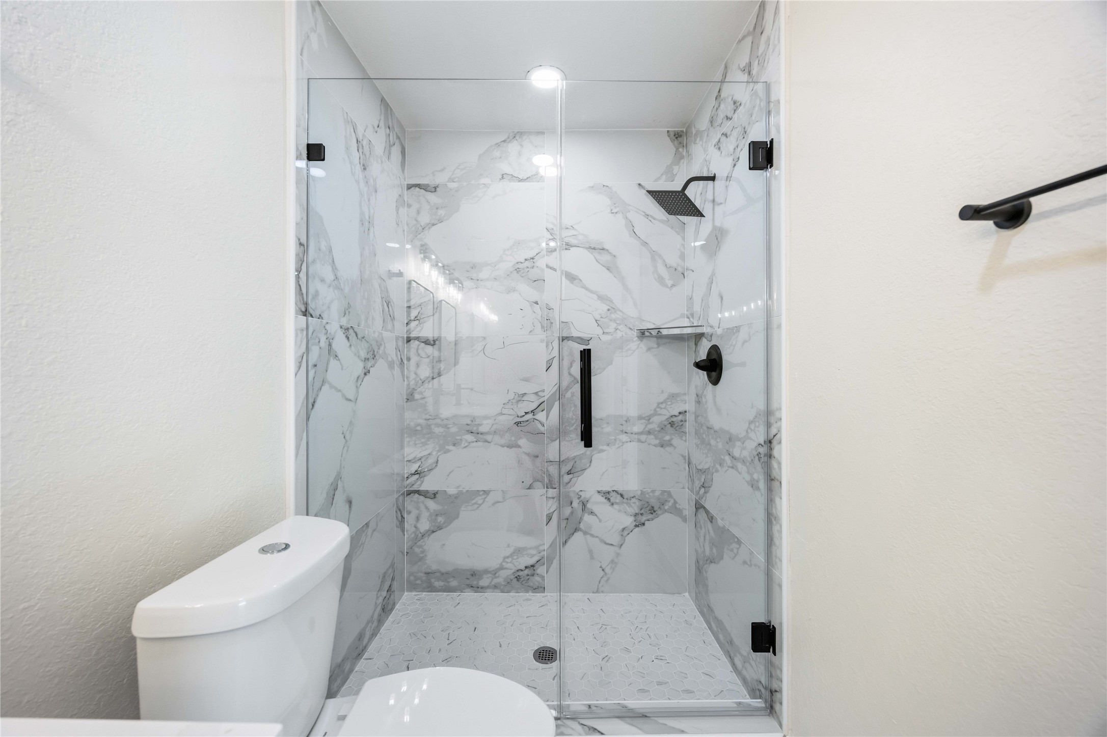 18234 Atkinson Lane Conroe, TX 77384 - Photo 16 of 30 a bathroom with a shower a toilet and a shower