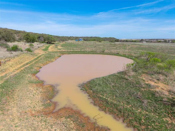 a view of a lake with sunset