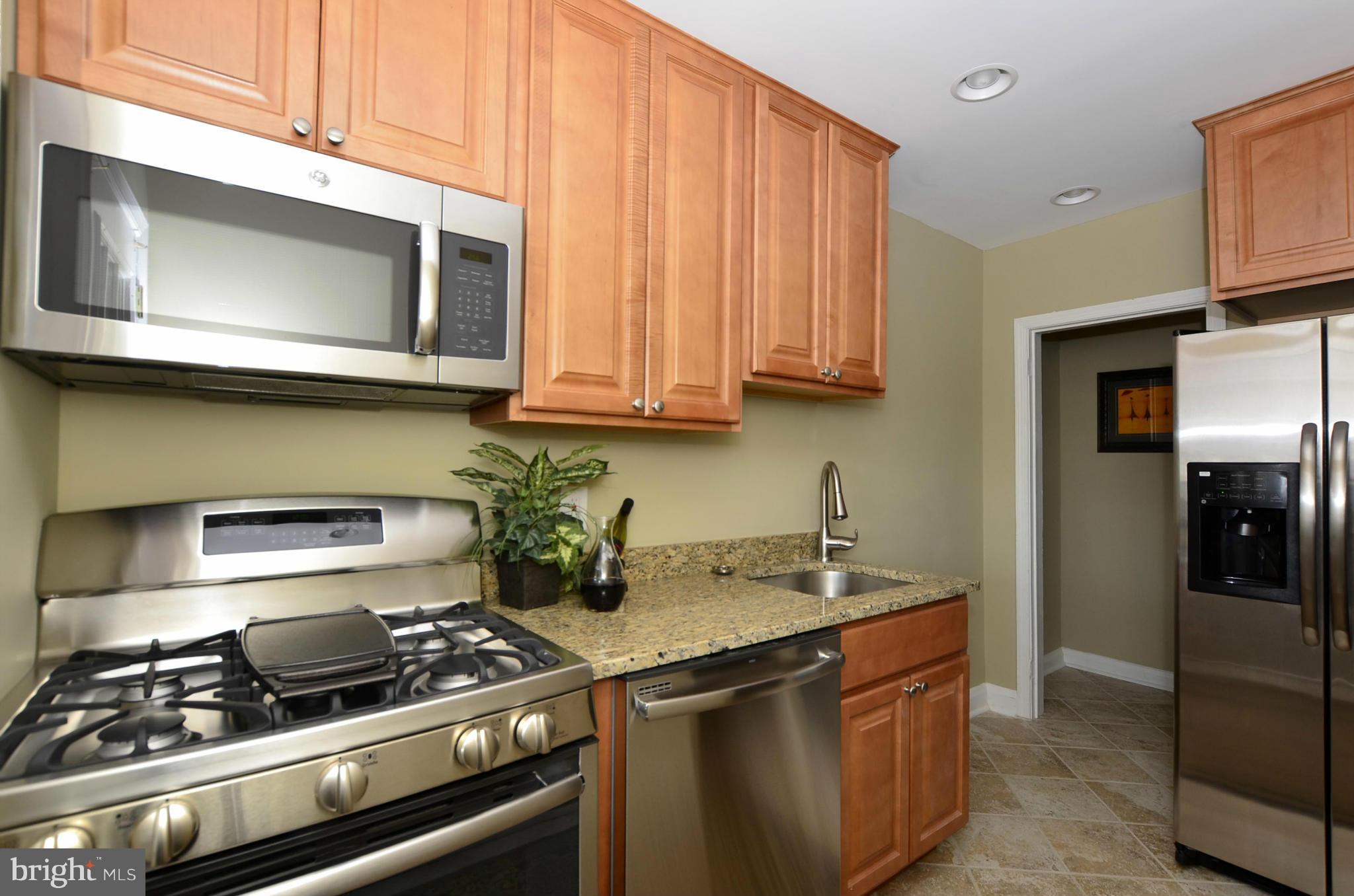 8253 Kavanagh Road Baltimore, MD 21222 - Photo 1 of 29 a kitchen with stainless steel appliances granite countertop a stove and a microwave