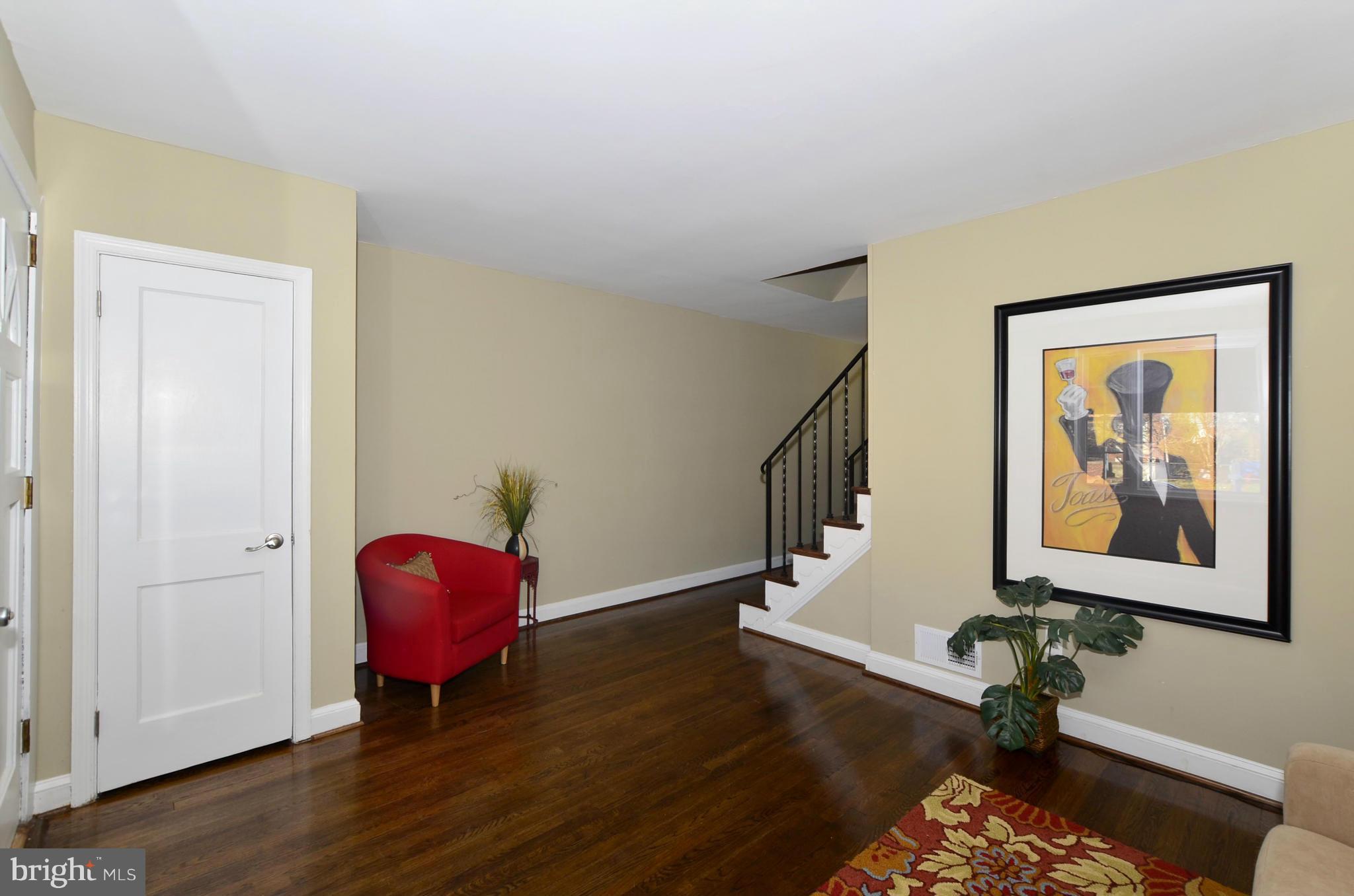 8253 Kavanagh Road Baltimore, MD 21222 - Photo 11 of 29 a view of a hallway with wooden floor and a workspace