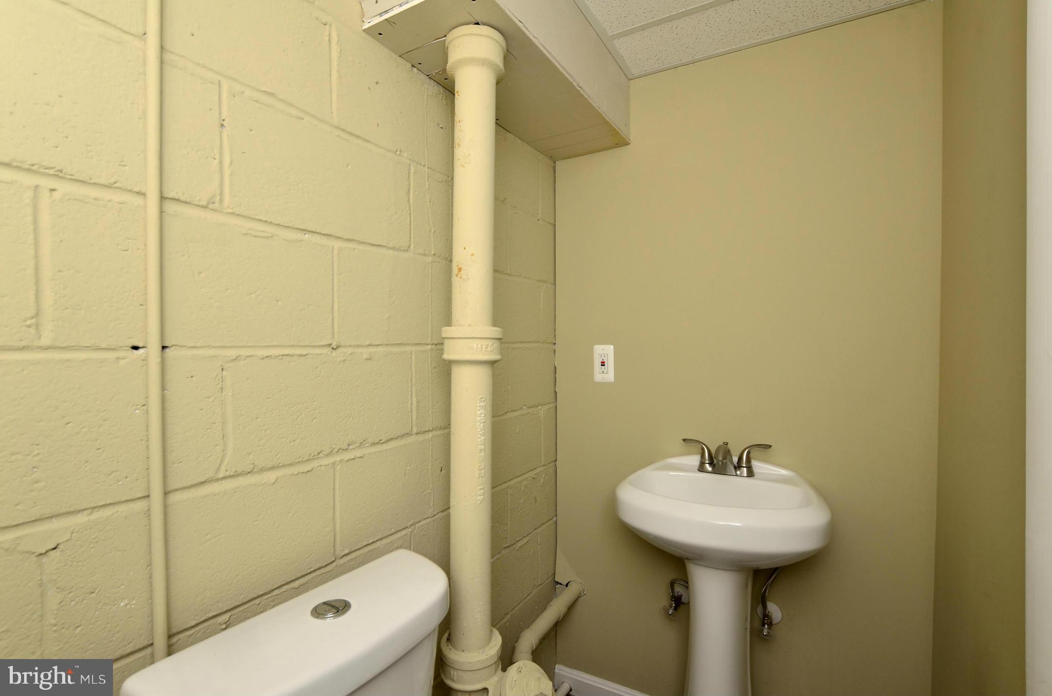 8253 Kavanagh Road Baltimore, MD 21222 - Photo 13 of 29 a bathroom with a sink toilet and shower