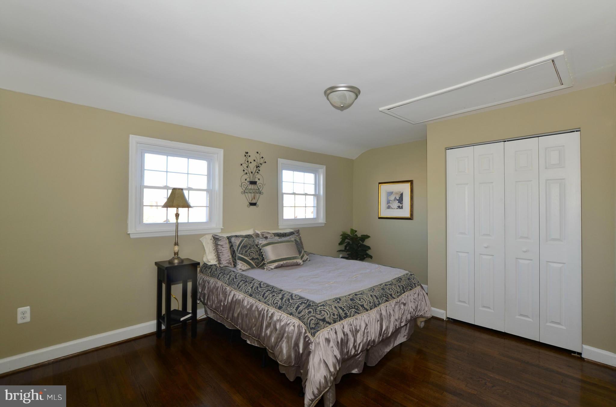 8253 Kavanagh Road Baltimore, MD 21222 - Photo 16 of 29 a bedroom with a bed and wooden floor