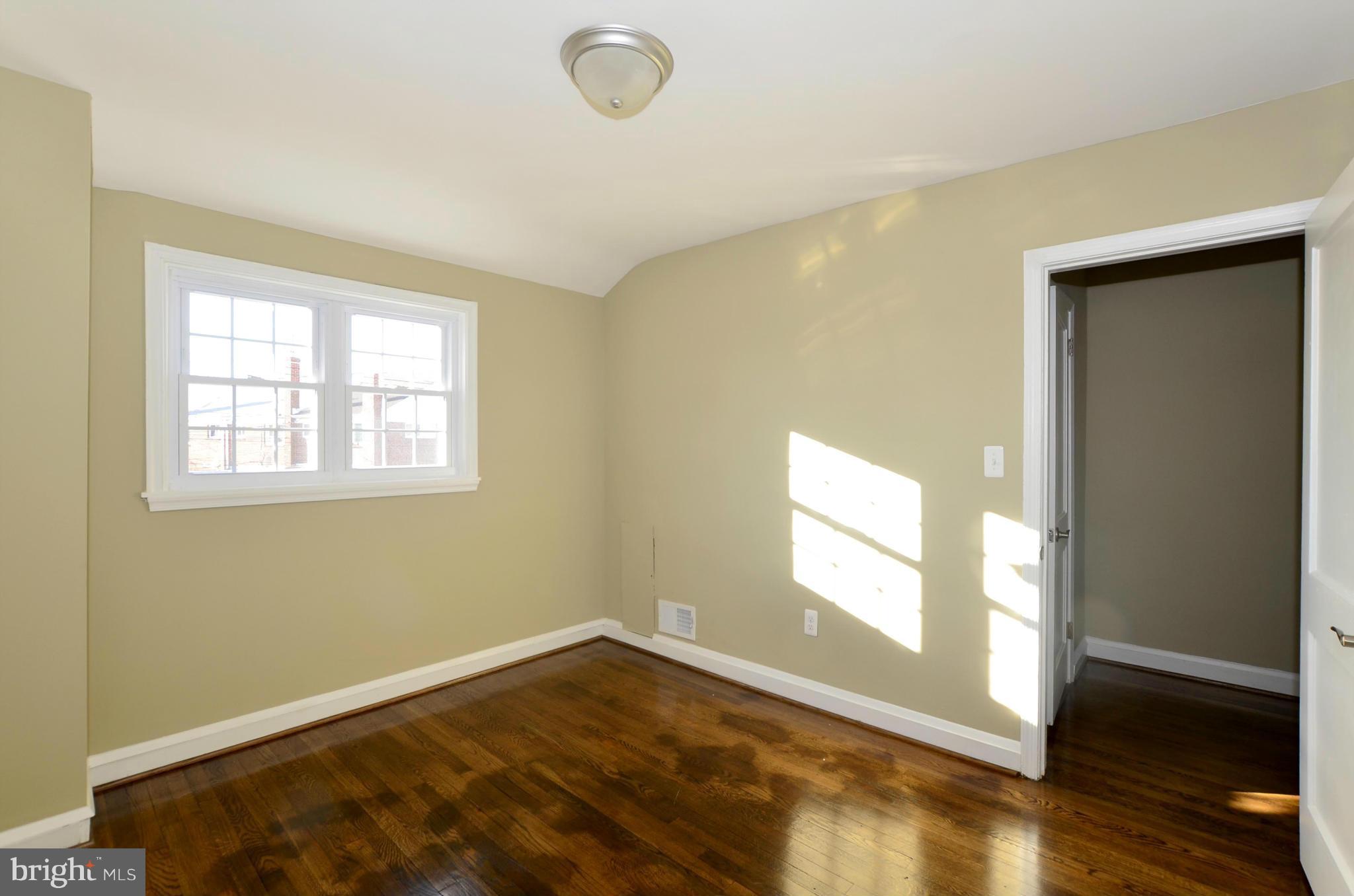 8253 Kavanagh Road Baltimore, MD 21222 - Photo 20 of 29 an empty room with wooden floor and windows