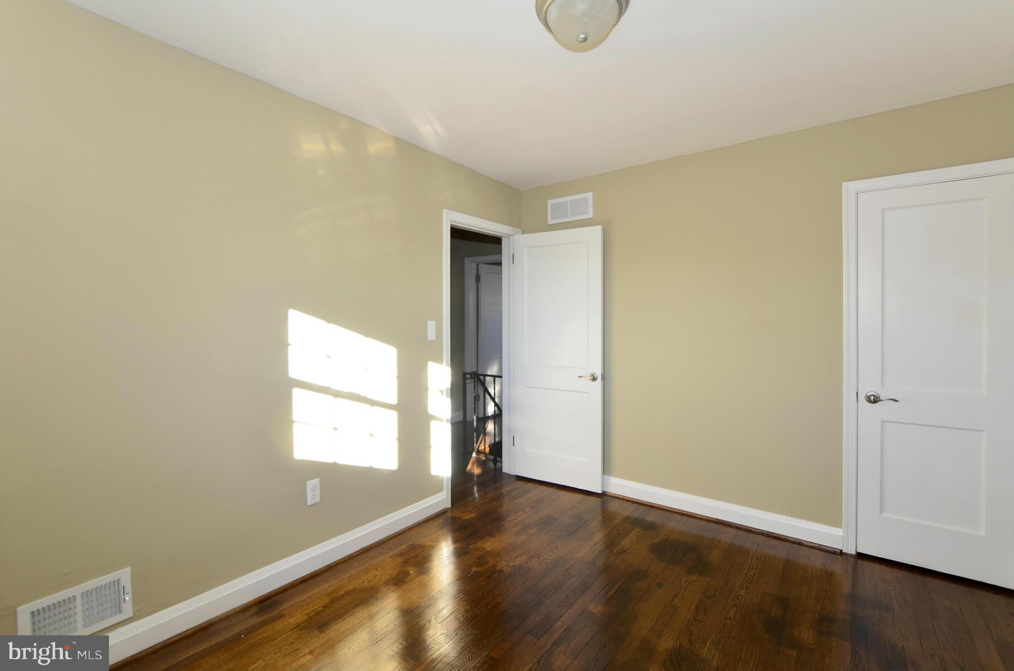 8253 Kavanagh Road Baltimore, MD 21222 - Photo 21 of 29 an empty room with wooden floor and windows