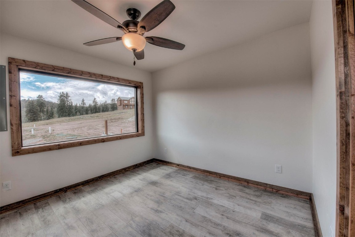 1835 Sheep Ridge Road Fairplay, CO 80440 - Photo 14 of 34 en empty room with window and ceiling fan