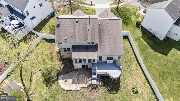 an aerial view of a house with swimming pool and outdoor seating