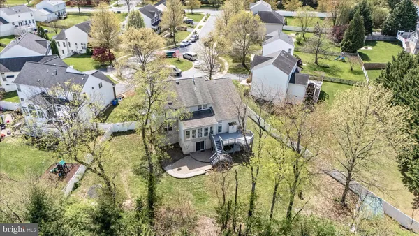 an aerial view of a house with a yard and outdoor seating