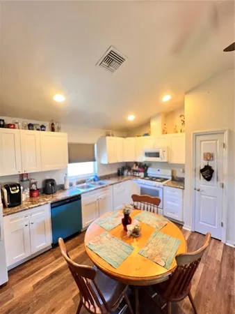 a kitchen with a table and chairs in it