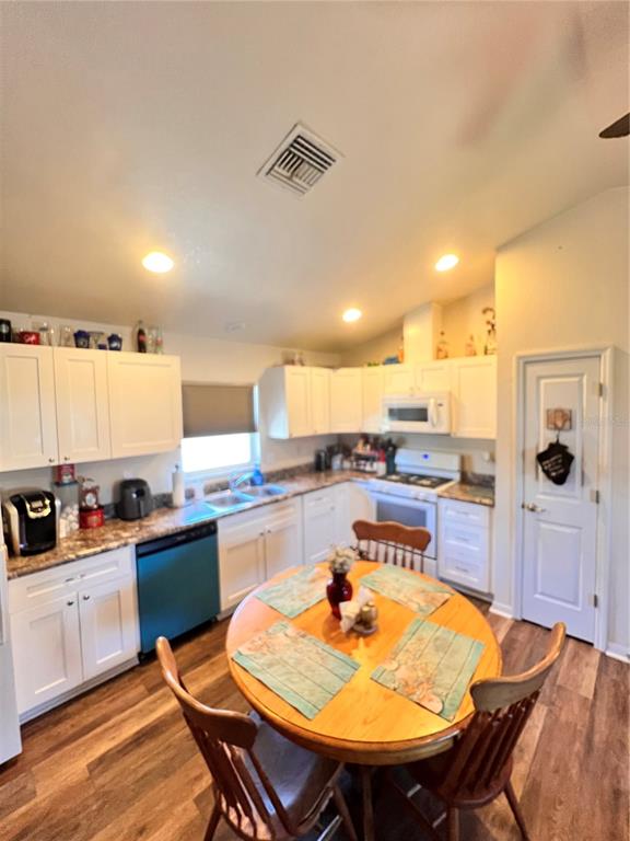 5351 Leisure Lane New Port Richey, FL 34652 - Photo 4 of 12 a kitchen with a table and chairs in it