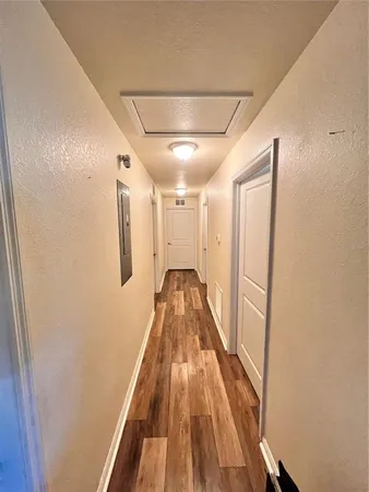 a view of a hallway with wooden floor