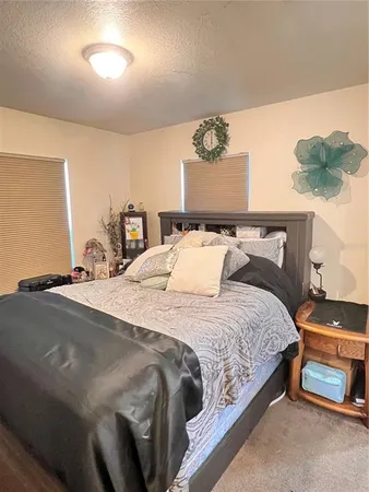 a bedroom with a bed and ceiling fan