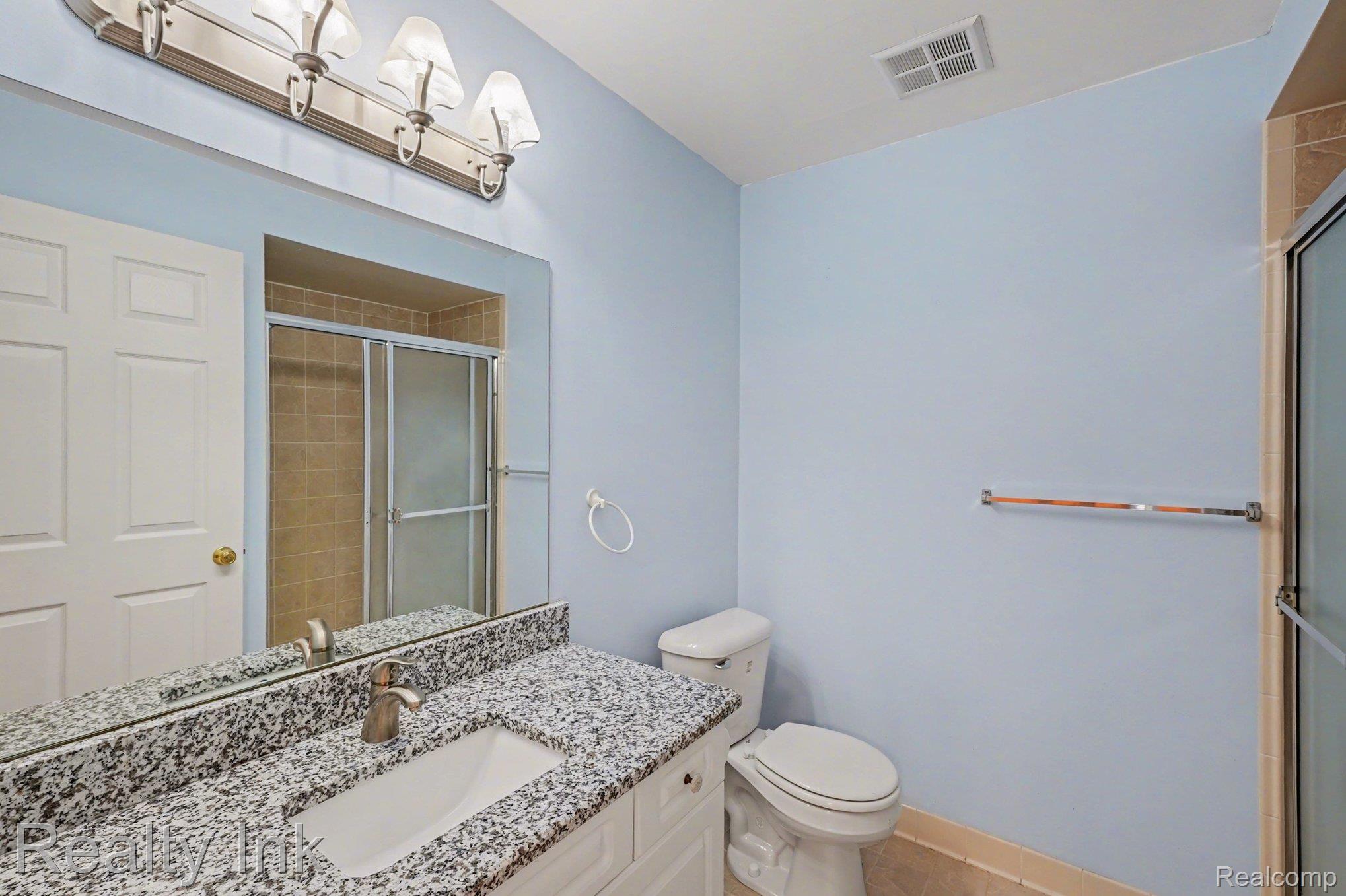 3399 Tremonte Circle Rochester, MI 48306 - Photo 8 of 14 Full bathroom featuring vanity and a tile shower