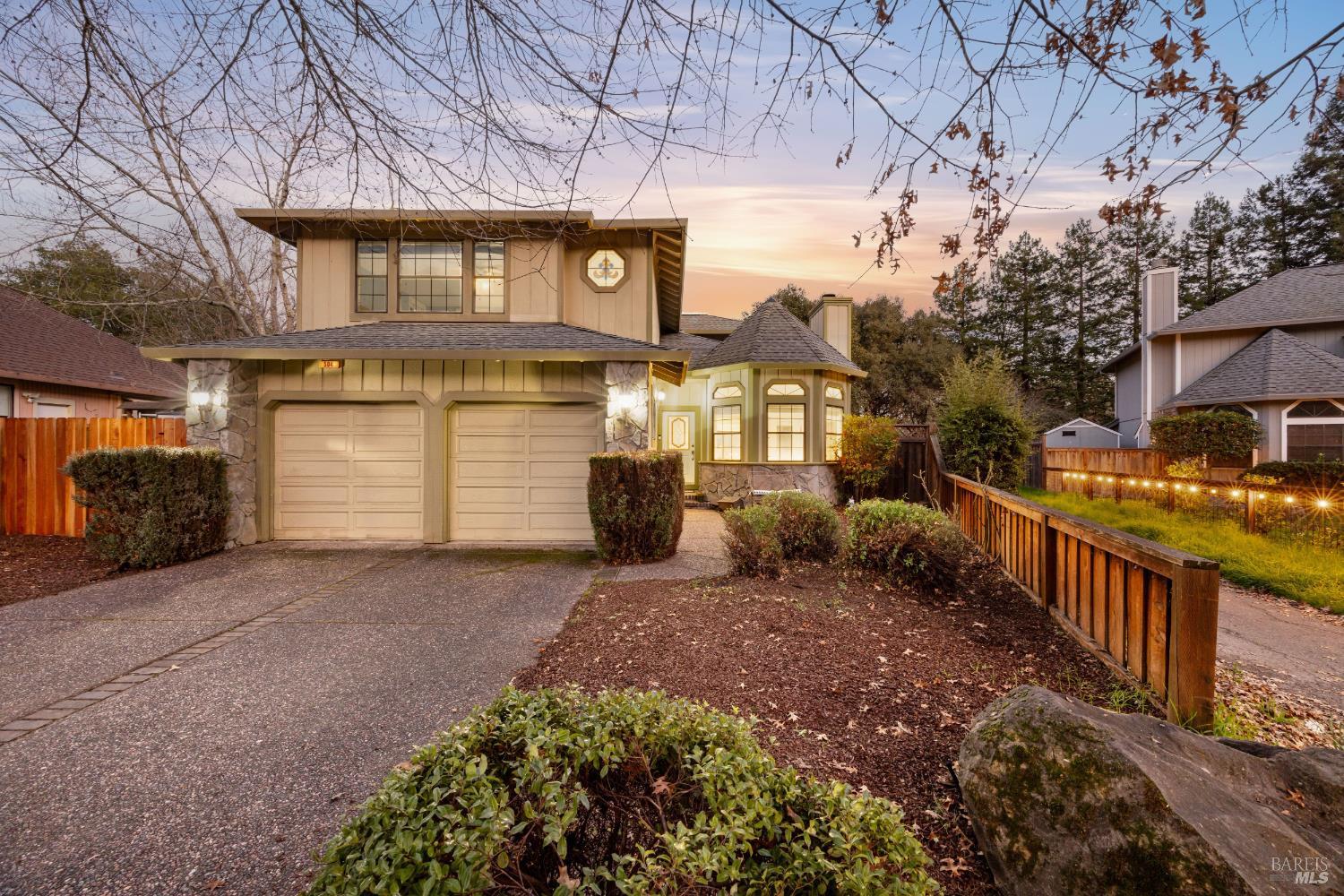 a view of a house with a yard and garage