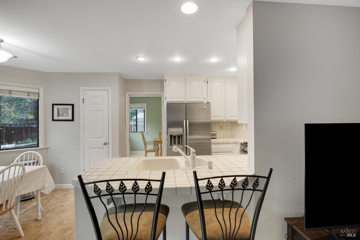 504 Jenifer Court Santa Rosa, CA 95404 - Photo 24 of 61 a view of a dining room with furniture a kitchen and wooden floor