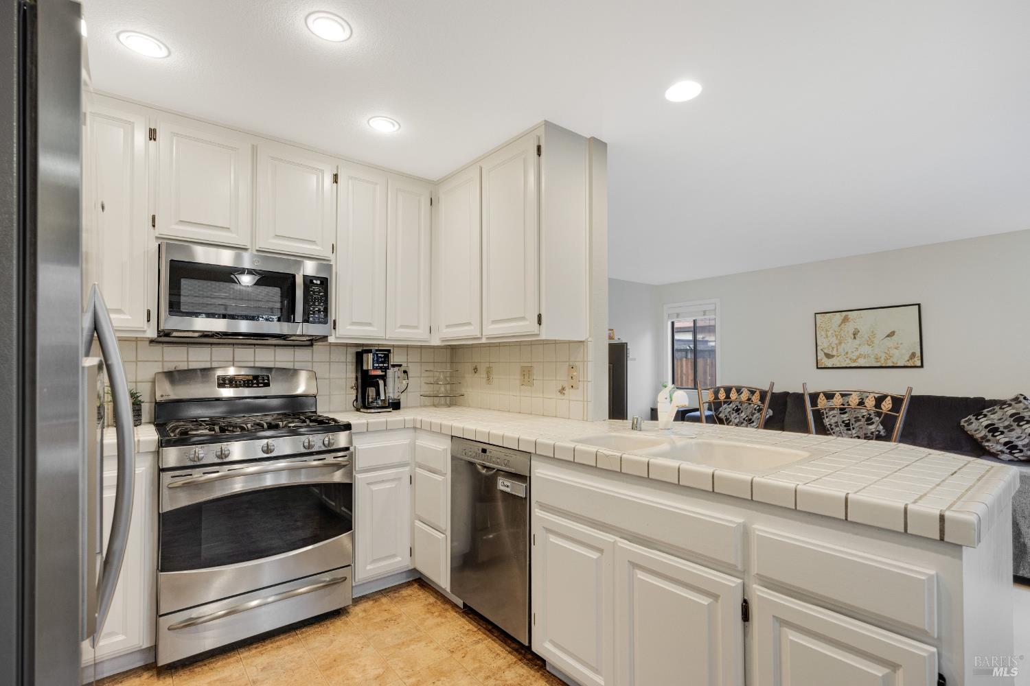 504 Jenifer Court Santa Rosa, CA 95404 - Photo 27 of 61 a kitchen with granite countertop white cabinets and stainless steel appliances