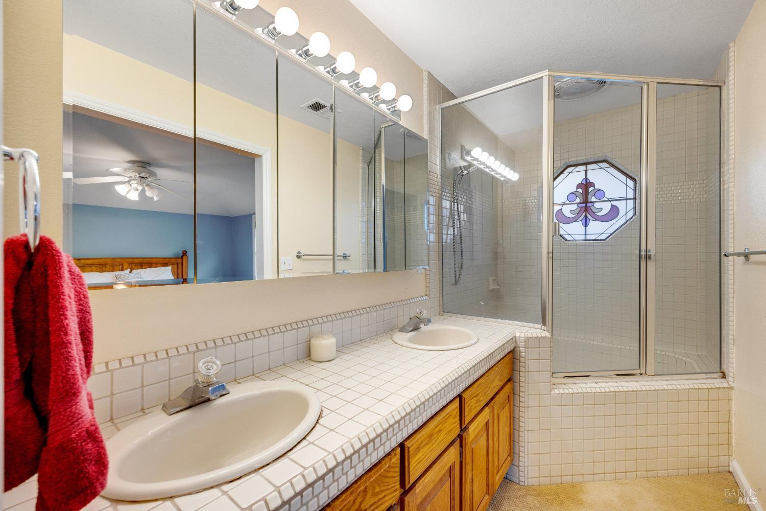 504 Jenifer Court Santa Rosa, CA 95404 - Photo 52 of 61 a bathroom with a sink double vanity and a mirror