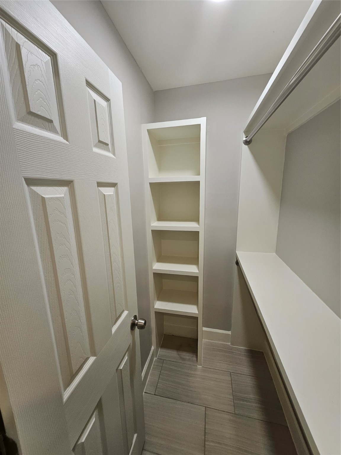 2101 Fountain View Drive, Unit 4 6 Houston, TX 77057 - Photo 12 of 26 a room with a closet and wooden shelves